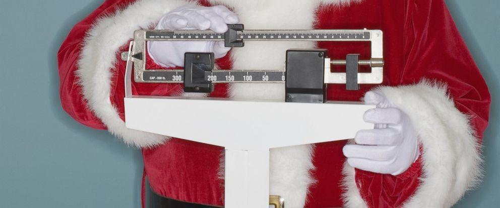person in Santa suit on weight scale